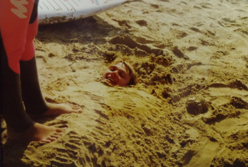 John buried in sand 1990